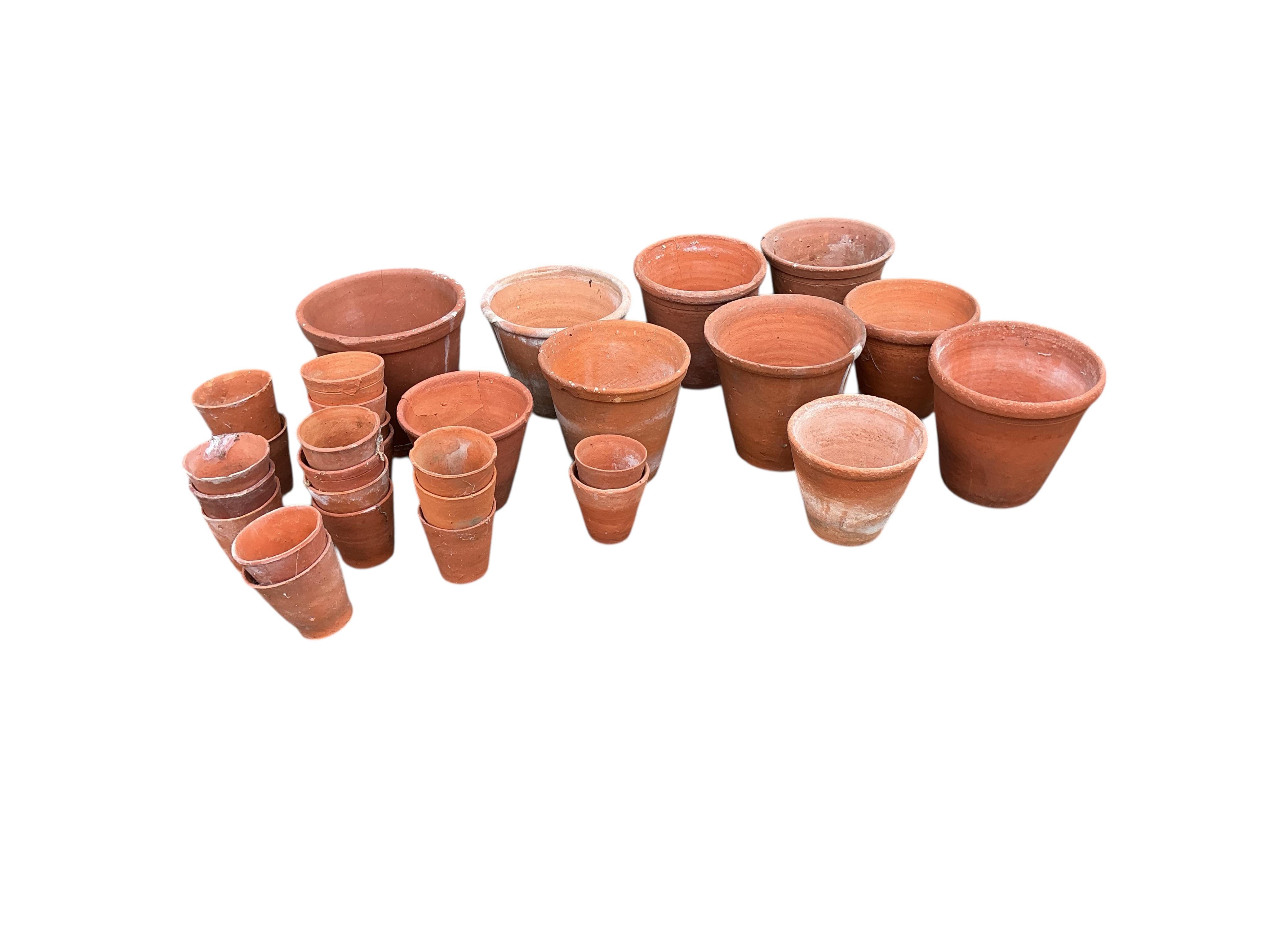 Thirty assorted circular terracotta garden pots, largest height 18cm